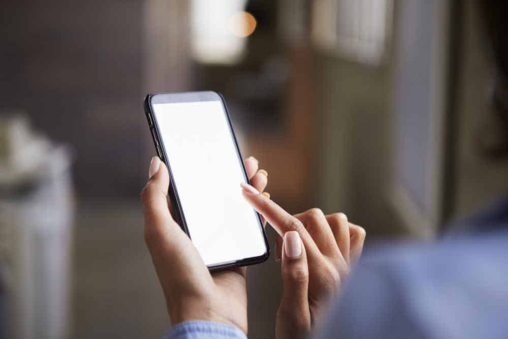 Close up of woman's hands using smartphone touchscreen